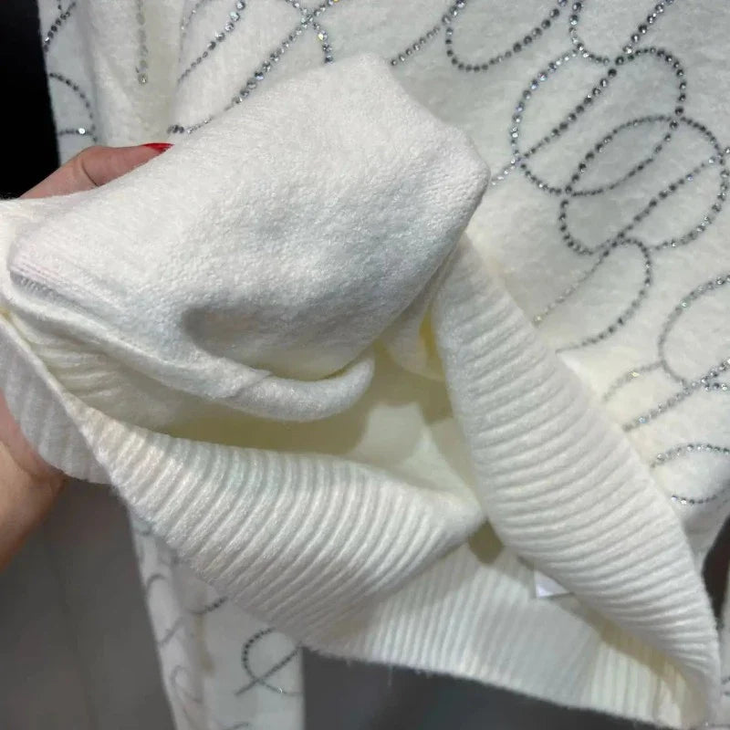 Faltenrock und Rollkragenpullover mit Pailletten und Strass